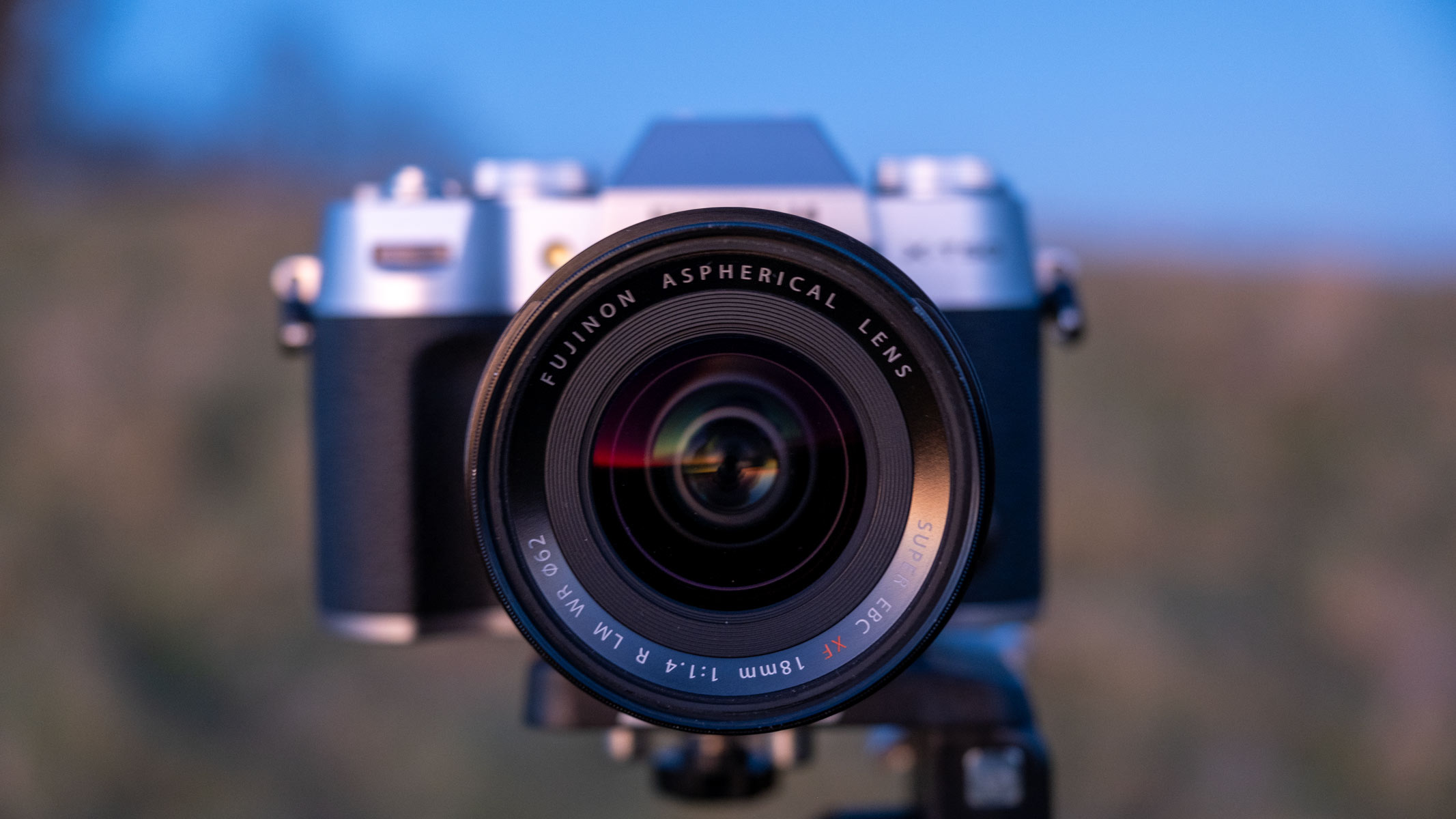 A Fujifilm X-T50 with a Fujifilm XF 18mm f/1.4 lens in a field in the evening