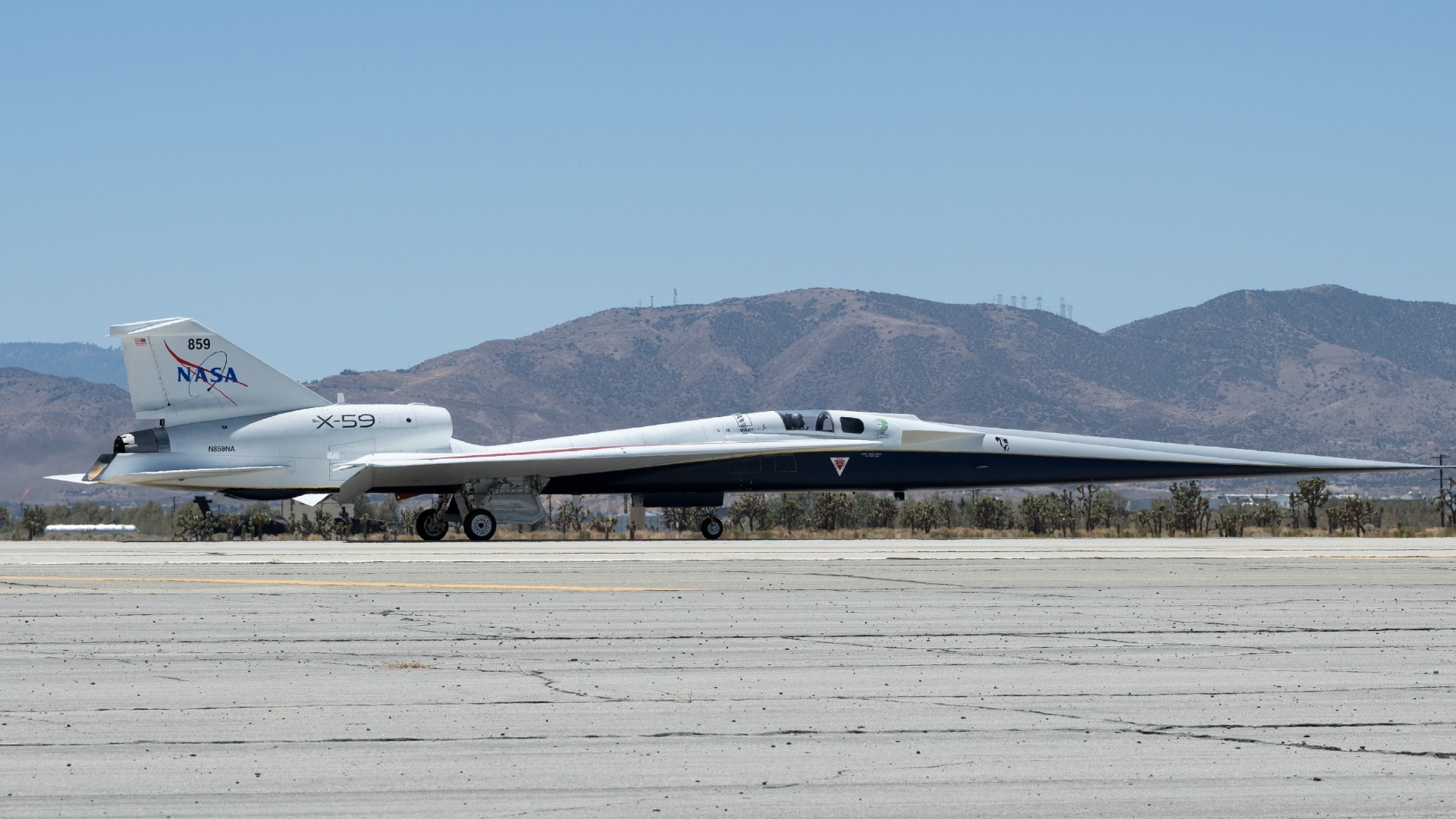 a long, slender aircraft drives across a runway